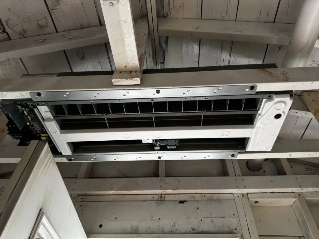 A mini-split ceiling cassette cleanly installed in an open-ceiling frame structure in the Capital District, NY,